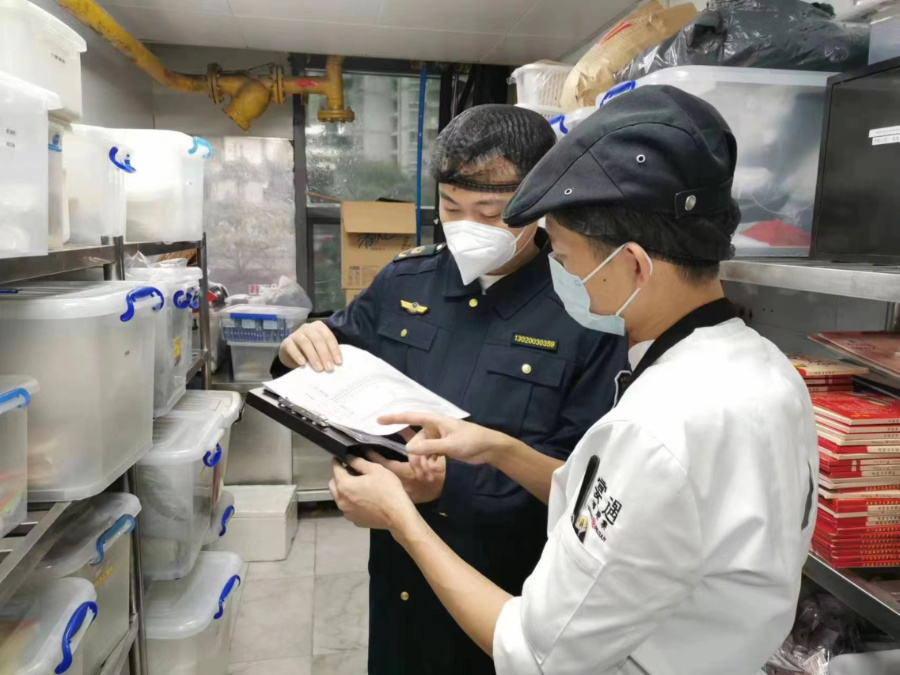 执法人员检查餐饮食材采购进货等情况。厦门市市场监督管理局供图