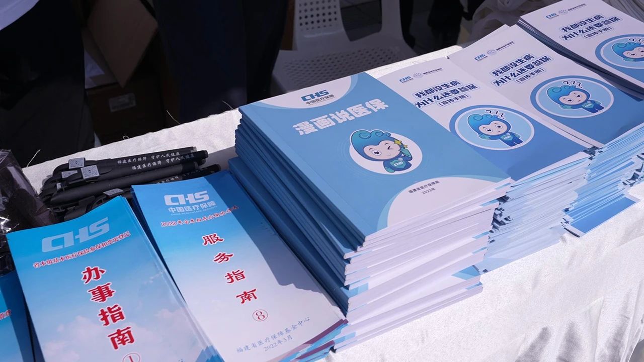 福建省医保局《漫画说医保》《我都没生病，为什么要参保》等宣传手册被送到市民手中。