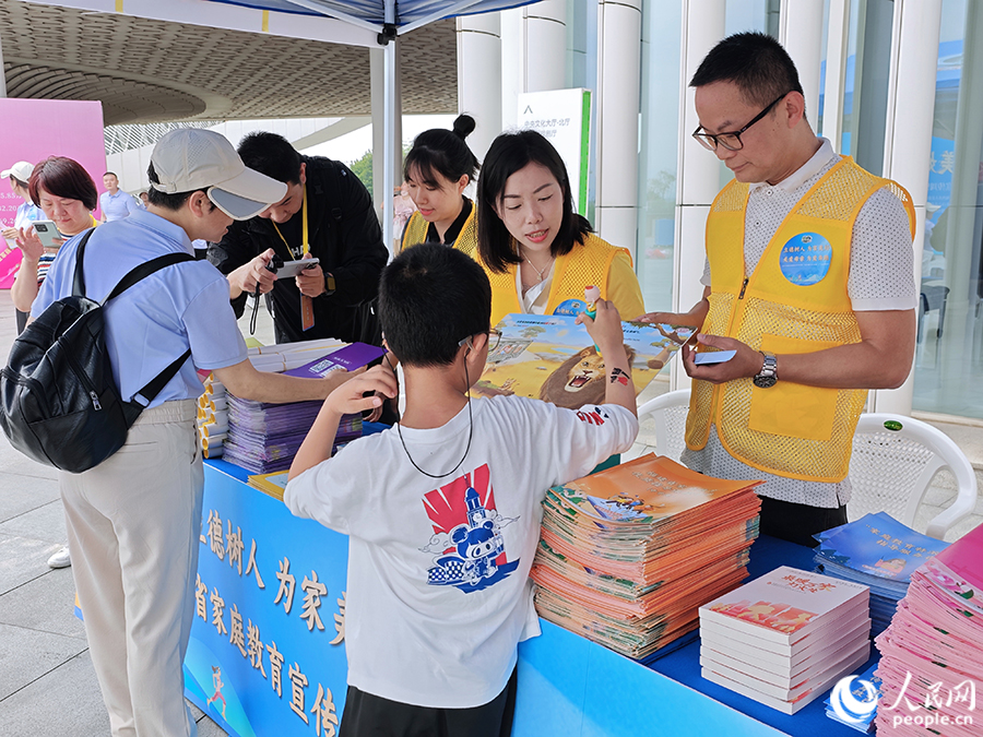 活動現場，工作人員向市民介紹家庭教育相關知識。人民網 黃東儀攝