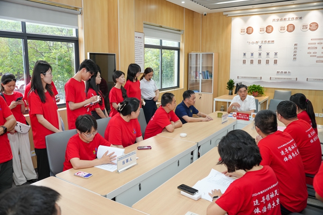 金牌调解员杨光照向实践队员介绍枫桥镇社会治理中心共享法庭的功能和应用