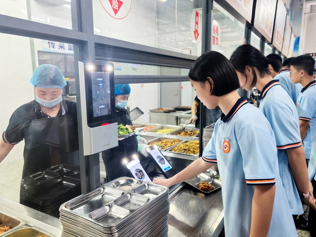 新學期開學首日，福建省福清第一中學學生在餐廳使用建行“智慧食堂”的刷臉支付有序就餐。建設銀行福建省分行供圖