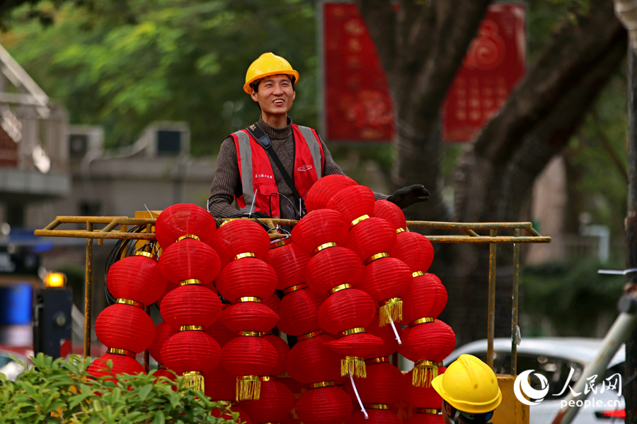 工人将成串灯笼挂上升降机。人民网记者 陈博摄