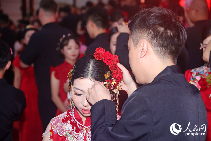 新郎专门为新娘簪上闽南非遗春仔花。人民网记者 陈博摄