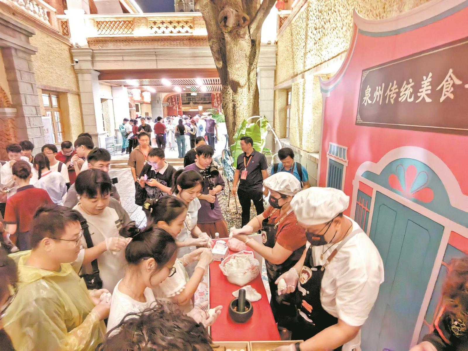 青年们在泉州传统美食手作区体验糖粿制作