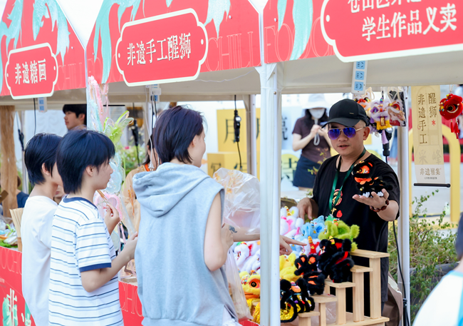 游客正在挑选手工醒狮
